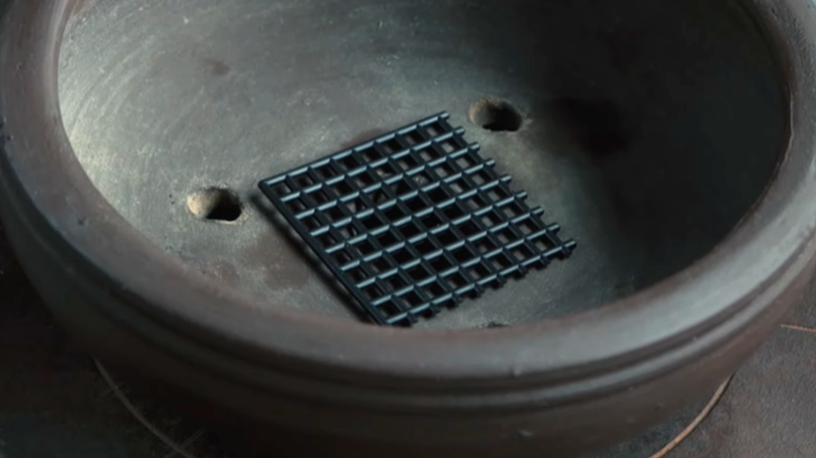 Drainage mesh covering a bonsai pot’s drainage hole